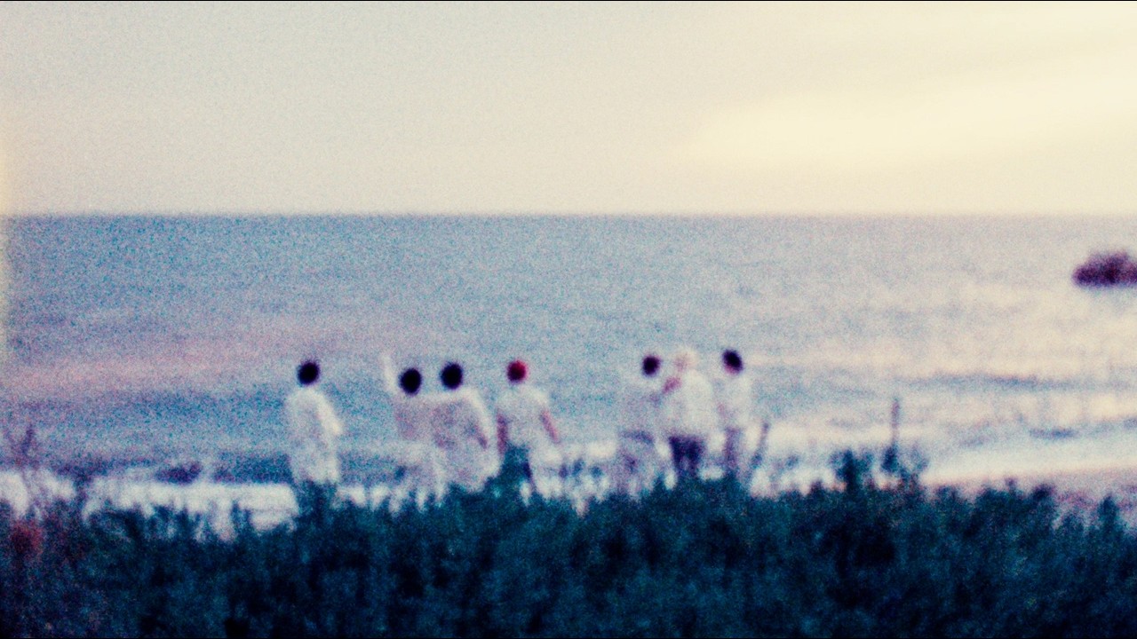 Still from AMPERS&ONE's official 'WE ARE UNCROWNED' main sequence video showing the members by the sea
